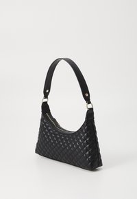 Black quilted handbag with a curved, short handle. Features a zip closure and gold-tone hardware. Made from textured synthetic material.