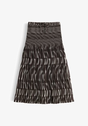 Jupe midi plissée noir et blanc avec motif abstrait de rayures verticales et taille élastique présentant un petit nœud noué à l'avant.