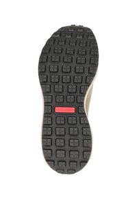 Schoenzool van gestructureerd zwart rubber, met een patroongreep en een rood logo-accent in het midden. Ronddelende vorm met een lichtgekleurde rand.