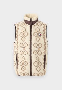 Fleece veste ar krēmkrāsas pamatni, brūnu ģeometrisku rakstu un priekšējo rāvējslēdzēju. Iezīmē sānu kabatas un augstu apkakli.