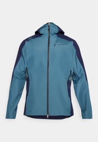 Veste imperméable teal et marine avec une capuche, fermeture éclair à l'avant et poches latérales zippées. Présente une texture extérieure lisse et une coupe ergonomique.