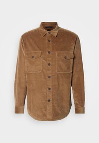 Brown corduroy shirt with long sleeves, button closure, two chest pockets, and a point collar. Features vertical ribbed texture.