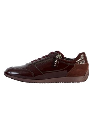 Burgundy sneaker featuring a glossy patent leather upper, suede accents, a front zipper, and a textured rubber sole for traction.