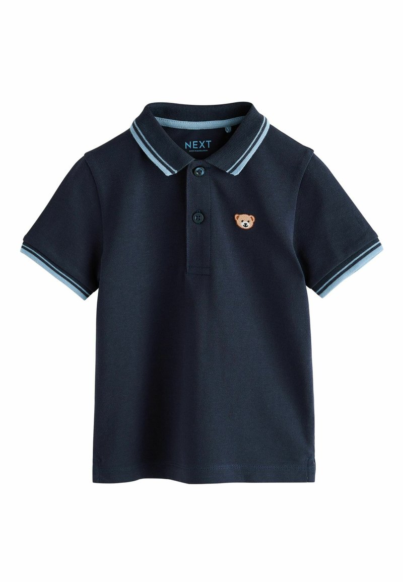 Tumesinistest tekstuurkangast polo-särk, millel on kraega kaelus ning hele sinised detailid krae ja varrukate peal. Sisaldab karu embleemi.