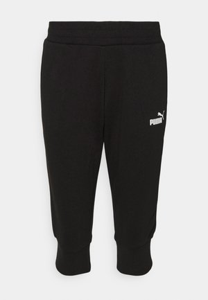 Schwarze Sweatpants mit geripptem Bund, cropped Länge und PUMA-Logo in Weiß auf der linken Seite. Weicher Stoff und lockere Passform.
