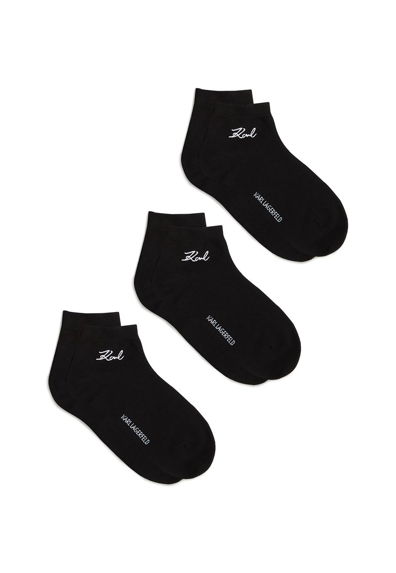 Trīs melnu potīšu zeķu pāri ar baltu "Karl" parakstu un "Karl Lagerfeld" tekstu uz baltas fona.