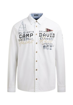 Long-sleeve white button-up shirt made of cotton, featuring various printed graphics in navy and gold, with gold buttons and a collar.