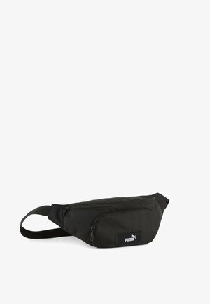 Riñonera negra Puma con dos compartimentos con cremallera y correa ajustable, diseñada para llevarla sin usar las manos.