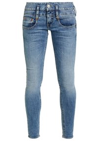 Blå denim skinny jeans med en bleknad yta, fem fickor och knäppning med knapp. Har kontrasterande sömmar och en avsmalnande ben.
