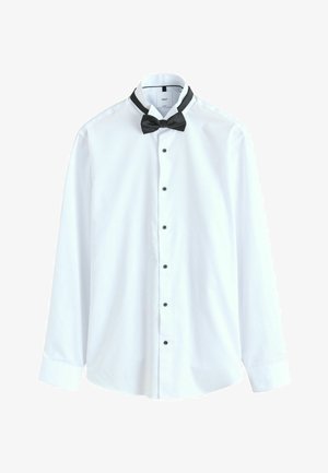White long-sleeve dress shirt with black buttons and a black pre-tied bow tie on a contrasting collar.