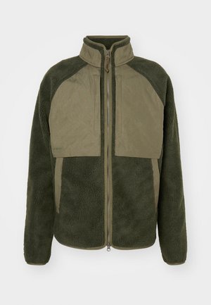 Green fleece jacket with a high collar, full front zipper, and contrasting panel design. Soft texture with pockets and ribbed cuffs.