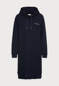 Marineblauwe hoodie jurkje van zachte katoen, met een gouden logo op de borst, zijzakken en geribbelde manchetten en zoom.