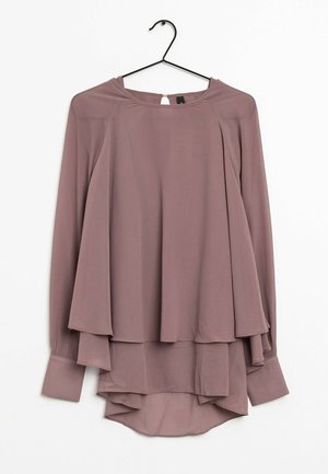 Långärmad mauveblus med lager av flödande tyg och knappstängning vid bakre halsringningen, hängande på en svart galge.