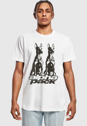 White cotton t-shirt featuring a black graphic of two dogs and the text "alpha pack" in bold typography below the design.