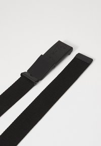Black woven belt with a rectangular plastic buckle. The buckle features a logo and a smooth texture, while the belt has a textured surface.