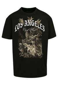 Svart bomull T-skjorte med detaljert grafisk trykk i beige, som skildrer kaotiske klassiske scener. Teksten lyder "LOS ANGELES City of Angels."