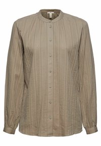 Beige Bluse mit langen Ärmeln, rundem Kragen, vertikalen strukturierten Streifen und Knopfleiste. Weicher Stoff mit dezentem Glanz.