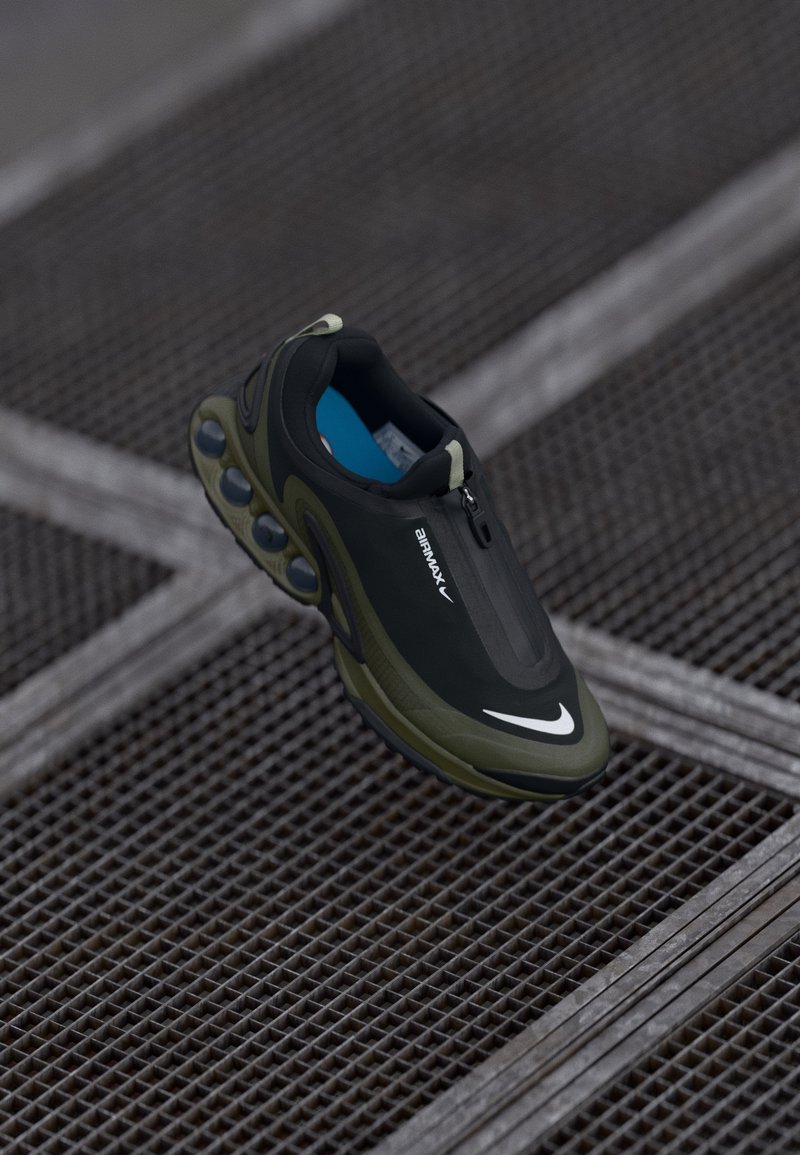 Čierne a olivové tenisky Nike Air Max s hladkým telom, zipsovým uzáverom a výraznými vzduchovými vankúšikmi na podrážke. Viditeľná modrá stielka.