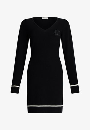 Black ribbed knit long-sleeve dress with V-neck, white trim on cuffs and hem, and small rhinestone logo on the left chest.