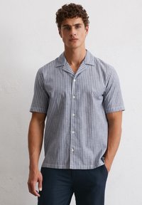 Short-sleeved button-up shirt in blue and white vertical stripes, featuring a notched collar and smooth fabric.