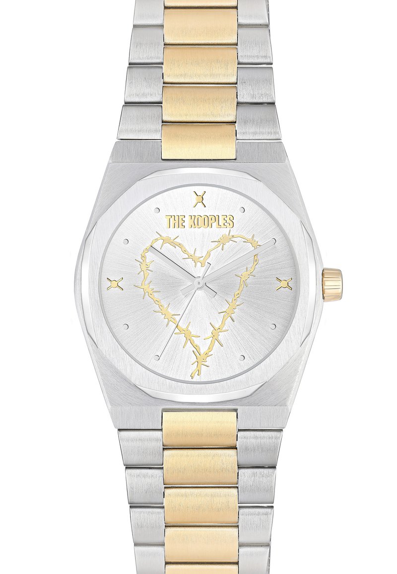 Orologio in acciaio inossidabile con accenti in oro giallo. Cassa ottagonale, quadrante argentato con un motivo a cuore in oro. Bracciale a maglie.