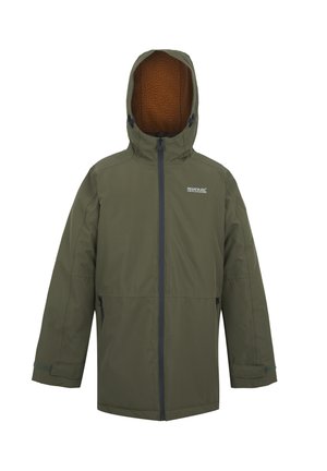 Chłopiec idący w oliwkowozielonej kurtce z kapturem, pomarańczowej polarowej bluzie, czarnych spodniach i beżowych butach, na tle jasnego, jednolitego tła.