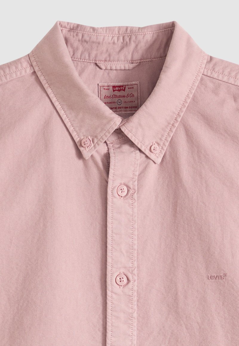 Hellrosa Hemd zum Knöpfen mit Kragen, Frontknöpfen und Levi's-Logo, das auf der Brust gestickt ist.