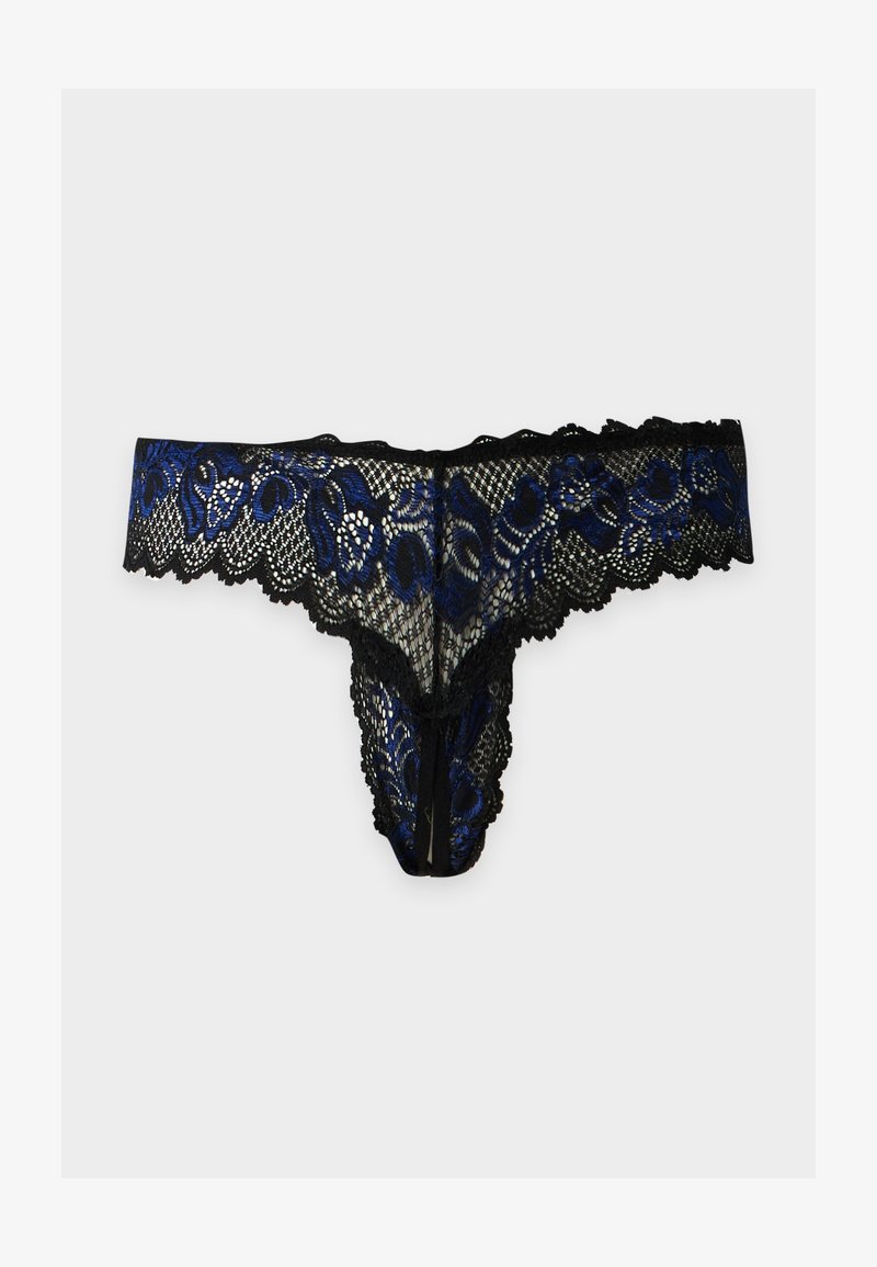 String en dentelle noire avec broderie florale bleue et bords festonnés sur un fond uni clair.