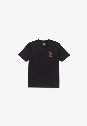 T-shirt en coton noir à manches courtes, avec un graphique coloré d'un serpent sur la partie gauche de la poitrine.