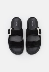 Black slide sandals with two suede straps, each featuring a silver buckle with embedded crystals, and branded insoles.