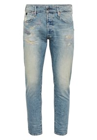 Light blue denim jeans with a slim fit, featuring distressed patches, fading, and a standard five-pocket design. Metal button closure.