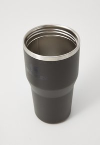 Black stainless steel tumbler with a tapered shape, smooth texture, and polished silver rim. Features engraved logo near the base.