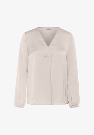 Blusa de manga larga color beige en tejido satinado. Presenta un escote en V y puños fruncidos. Brillo sutil, corte holgado y detalle de abertura lateral.