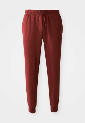 Marron jogger-housut pehmeästä kankaasta, jossa on joustava vyötärö, jossa on nyöri, ja tiukat hihat nilkoissa.