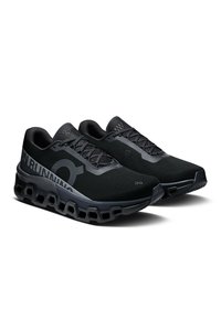 Schwarze Laufschuhe mit einer strukturierten Oberseite, hexagonaler Dämpfungsohle und reflektierenden Akzenten. Entwickelt für Komfort und Unterstützung.