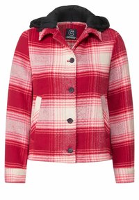 Red and cream plaid flannel jacket with a black hood. Features button closure and two front pockets. Soft texture with visible pattern.