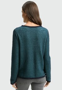 Teal knit sweater with horizontal stripes, crew neck, and ribbed cuffs. Soft texture, slightly cropped at the back, and dark trim at neckline and hem.