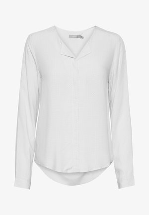 Dlhý rukáv, ľahká blúzka v bielej farbe so subtílnym textúrovaným vzorom, výstrih do V, zaoblený lem a gombíkovými manžetami.