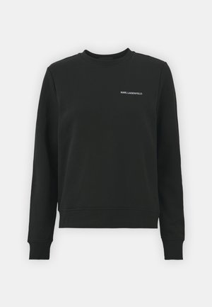 Svart sweatshirt med långa ärmar, rundad halsringning och ribbade muddar. Har en liten vit "KARL LAGERFELD"-logotyp på framsidan. Minimalistisk design.
