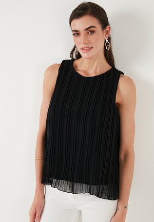 Black sleeveless top with vertical pleats, round neckline, and a flowing silhouette. Made of lightweight fabric with a layered texture.