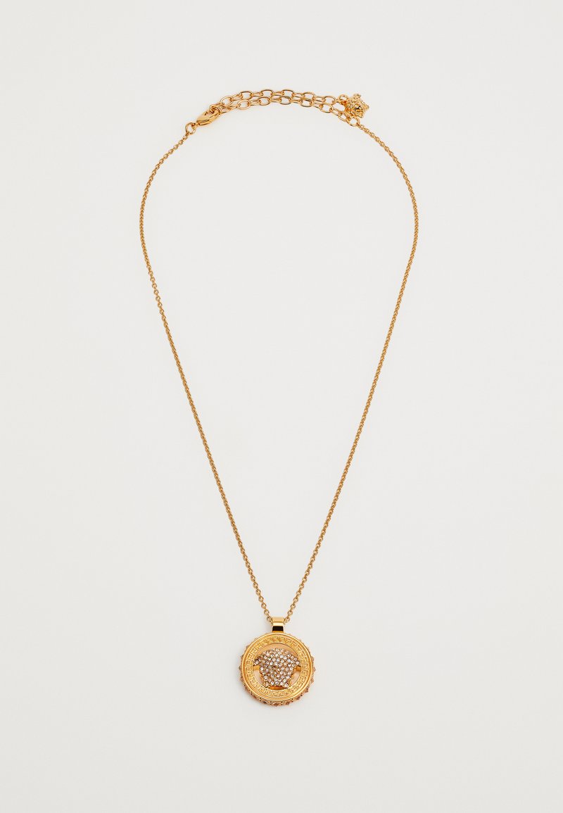 Kuldtooniline kaelakee, millel on ümmargune ripats tekstuuriga äärega, kaunistatud selgete ja roosade kividega. Kett sisaldab lukku.