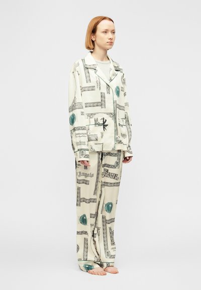 Σετ λευκής πιτζάμας με λεπτομερή μαύρα και  τιρκουάζ γραφικά σχέδια. Μαλακό, λείο ύφασμα με άνετη εφαρμογή και αντίθετη επένδυση στο σακάκι.