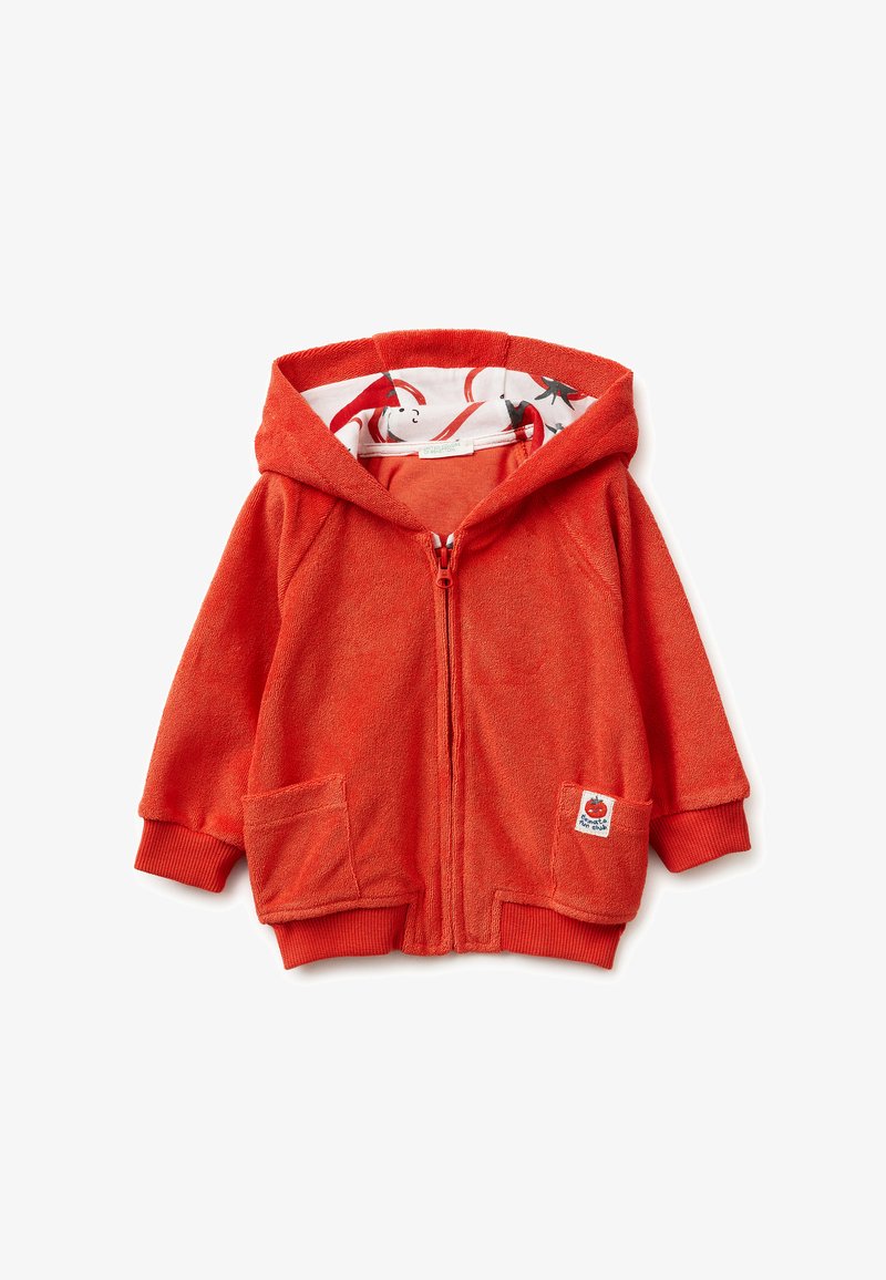 Oranje ritssluiting kinderjack met capuchon, voorzakken, geribbelde manchetten en een capuchonvoering met chilipeperpatroon.