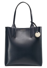 Marineblaue Ledertasche mit zwei oberen Griffen, strukturierter Oberfläche und goldfarbener Logoschild-Akzentuierung. Verfügt über eckige Ausschnitte an der Griffbefestigung.