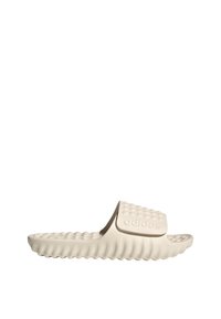 Kärry sandaalit vaaleanbeigessä värissä, joissa on teksturoitu, kohotettu pistemäinen kuvio hihnassa ja kaareva, uritettu pohja. Hihnassa on logo.