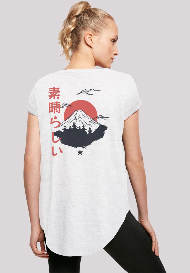 White short-sleeve t-shirt featuring a graphic of Mount Fuji, red sun, clouds, and Japanese text on the back. Soft fabric, relaxed fit.