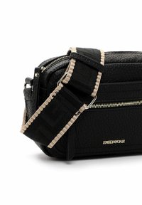 Black textured leather bag with silver zipper details, a patterned strap, and gold logo. Features a compact rectangular shape.