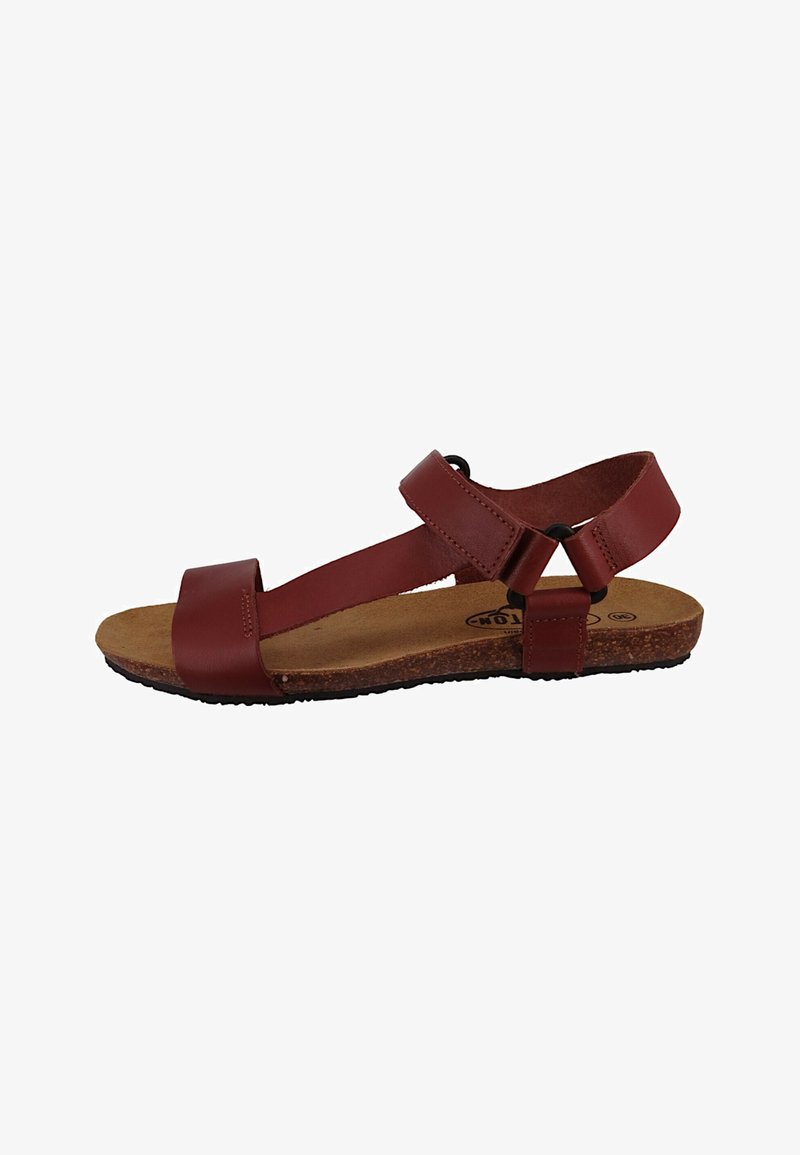 Brown leather sandal featuring a wide strap, adjustable ankle strap, cork sole, and minimal hardware accents.