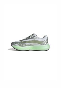 Silver athletic shoe with mesh upper, green translucent sole, curved shape, and streamlined design. Features laces and no visible branding.