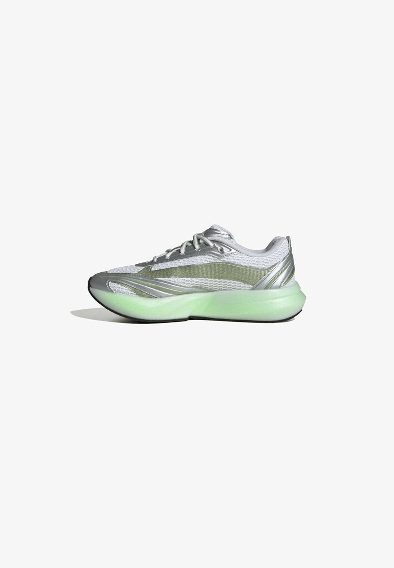 Silver athletic shoe with mesh upper, green translucent sole, curved shape, and streamlined design. Features laces and no visible branding.